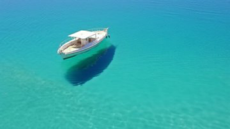 An optical illusion created by extremely clear glass-like water, The water is so clear, ethereal, boat shadow is completely detached...