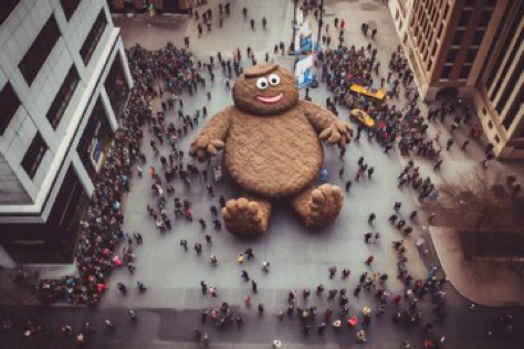 Prompt: ‘’A droneshot of crowd around the tallest cookiemonster statue in the world. City square, New York. --ar 3:2’’