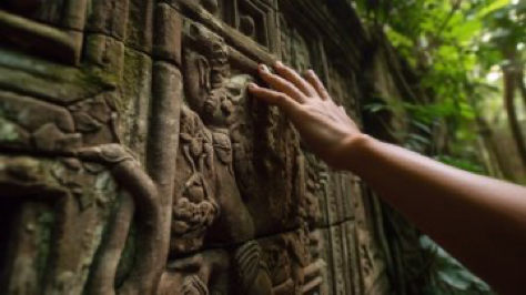 A photo from first person POV, while discovering an ancient temple hidden in the jungle, with a focus on the...